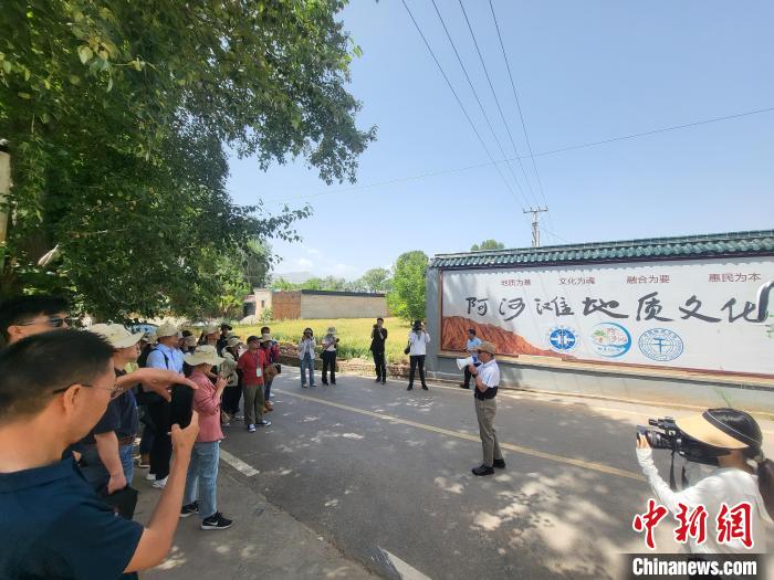 圖為中國(guó)地質(zhì)大學(xué)(北京)教授張緒教介紹村落情況。　胡友軍 攝