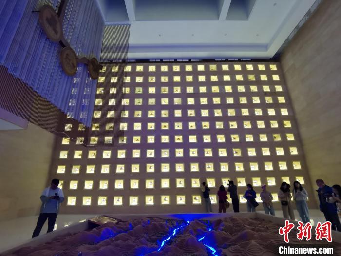 圖為河湟文化博物館序廳的左右彩陶墻放置的374件彩陶?！?zhí)砀?攝