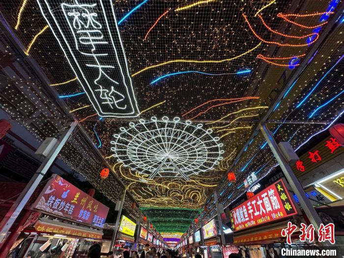 圖為明清街夜市燈光點(diǎn)亮具有武威文化元素的“摩天輪”彩燈?！〈魑牟?攝</p><p>